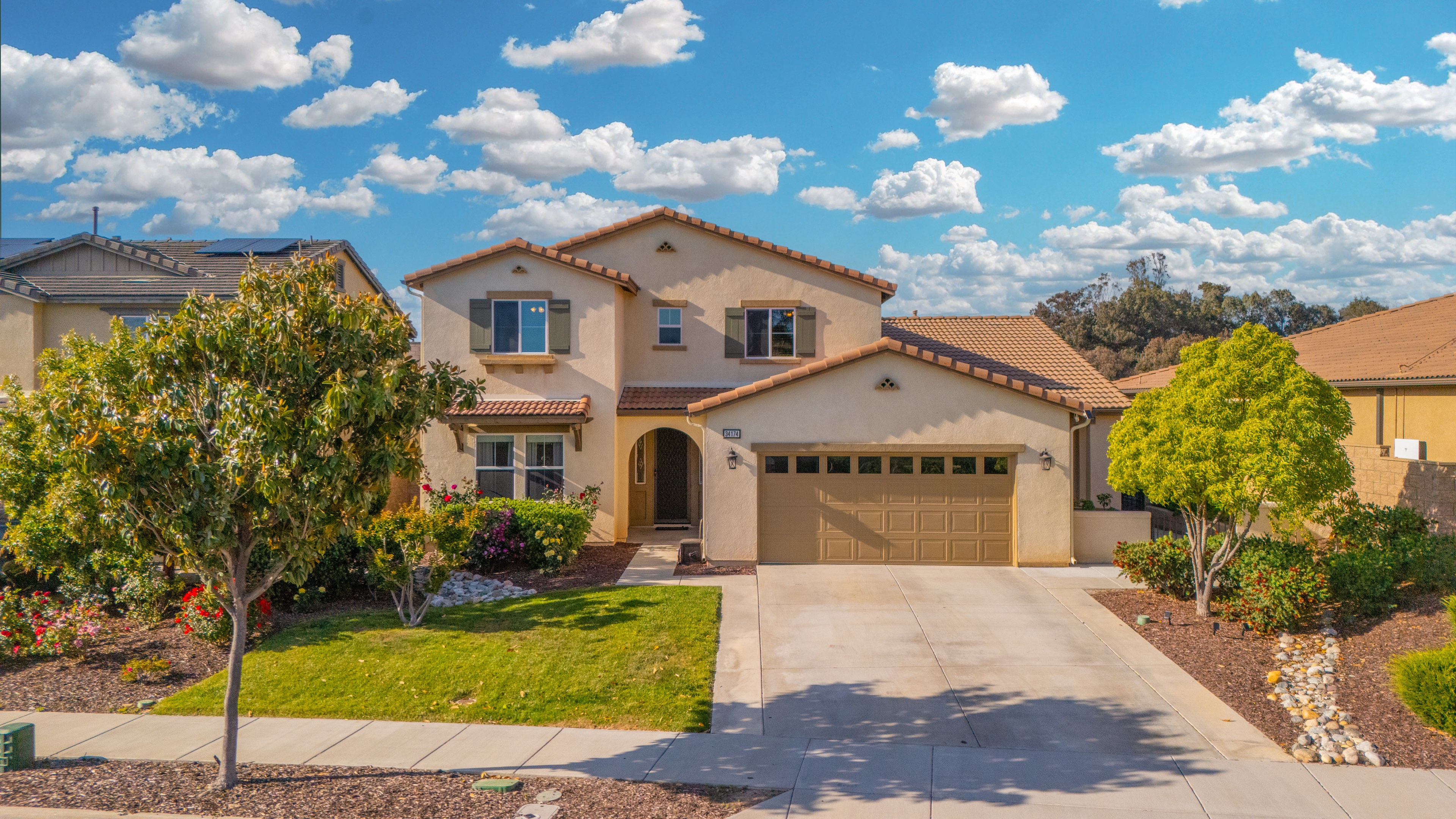 Aerial view of Mediterranean-style home with dramatic sky